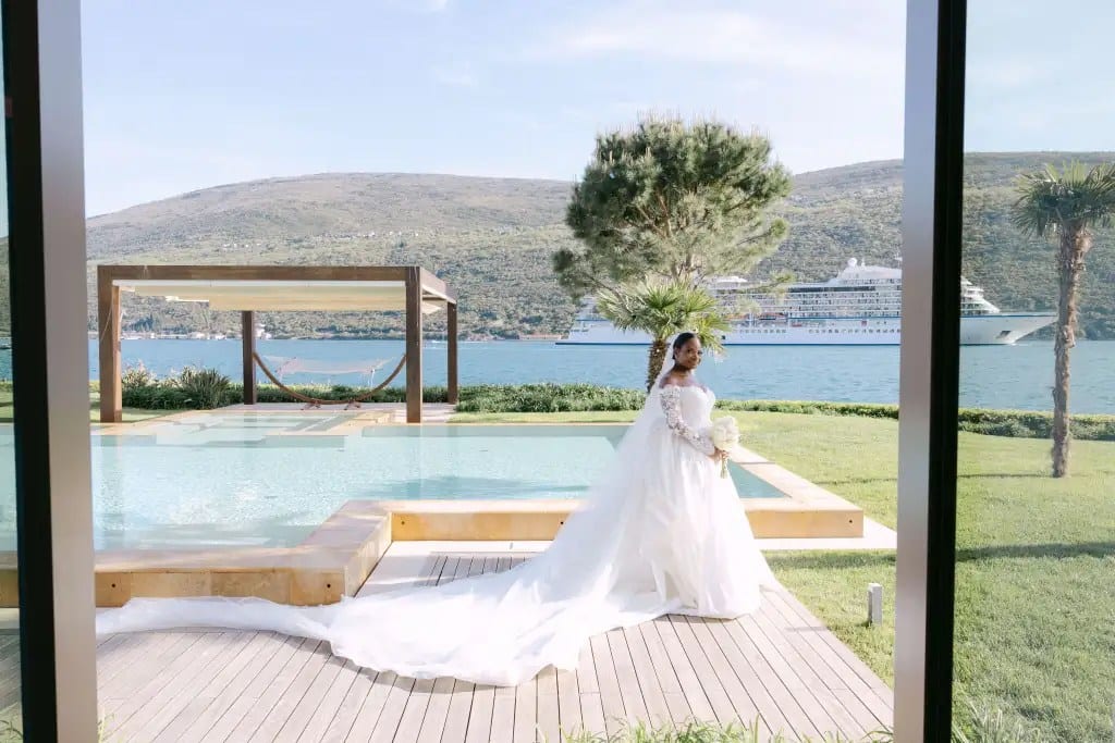 Bride at infinity pool with Adriatic bay and luxury waterfront hotel